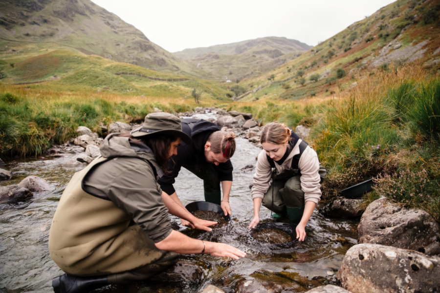 Three people panning for gold in the Wanlockhead area of southern Scotland.